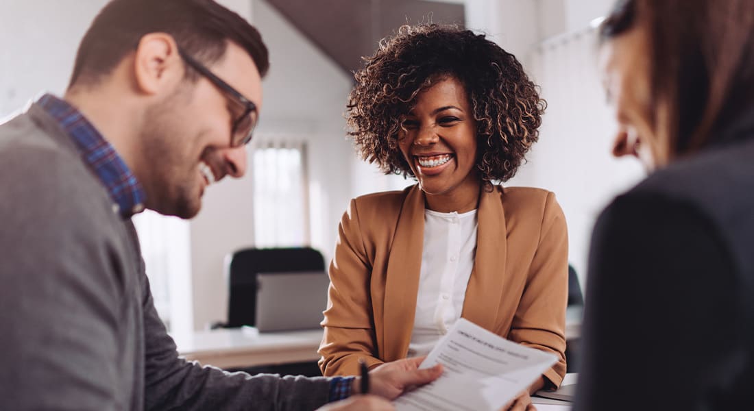 An agent getting a contract signed after a real estate listing presentation.